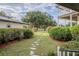 Landscaped yard with stone path and lush greenery at 16600 Cleveland Ln, Umatilla, FL 32784