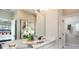 Double vanity bathroom with white cabinets and a large mirror reflecting the bedroom at 1231 Teal Creek Dr, St Cloud, FL 34771