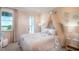 Charming bedroom with a canopy bed, soft pink color scheme, and plenty of natural light at 1231 Teal Creek Dr, St Cloud, FL 34771