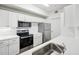 Bright kitchen boasts stainless steel appliances and white shaker cabinets at 5536 Metrowest Blvd # 8-304, Orlando, FL 32811