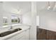 Modern kitchen with white cabinets, stainless steel appliances, and quartz countertops at 5536 Metrowest Blvd # 8-304, Orlando, FL 32811