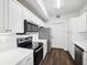 Modern white kitchen with stainless steel appliances at 5536 Metrowest Blvd # 8-304, Orlando, FL 32811