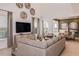 Spacious living room with large sectional sofa, high ceilings, and modern decor at 1227 Teal Creek Dr, Saint Cloud, FL 34771