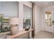 Bright entryway with light wood console table and large windows at 1227 Teal Creek Dr, Saint Cloud, FL 34771