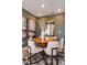 Elegant dining area, featuring a round wooden table and neutral decor at 1227 Teal Creek Dr, Saint Cloud, FL 34771