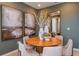 Modern dining area with round table, neutral chairs and artwork at 1227 Teal Creek Dr, Saint Cloud, FL 34771