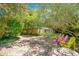 Spacious brick patio with colorful chairs, lush landscaping, and a private, fenced yard at 1650 Lakehurst Ave, Winter Park, FL 32789