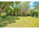 Brick house with lush landscaping, a large yard, and mature trees at 1650 Lakehurst Ave, Winter Park, FL 32789