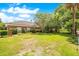 Large grassy backyard with mature trees and brick home at 1650 Lakehurst Ave, Winter Park, FL 32789