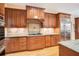 Spacious kitchen featuring wood cabinets, granite counters, and stainless steel appliances at 1650 Lakehurst Ave, Winter Park, FL 32789