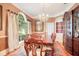 Formal dining room with large table and hutch at 1650 Lakehurst Ave, Winter Park, FL 32789