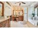 Luxurious bathroom with granite countertops, a soaking tub, and a walk-in shower at 1650 Lakehurst Ave, Winter Park, FL 32789