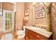 Elegant bathroom with granite vanity, decorative wallpaper, and a shower at 1650 Lakehurst Ave, Winter Park, FL 32789