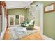 Relaxing sunroom with green walls, two armchairs, and a large window at 1650 Lakehurst Ave, Winter Park, FL 32789