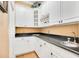 Butler's pantry with white cabinets, granite countertops, and wine rack at 1650 Lakehurst Ave, Winter Park, FL 32789
