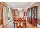 Elegant formal dining room with large table, hardwood floors, and window seating at 1650 Lakehurst Ave, Winter Park, FL 32789