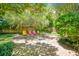 Brick patio surrounded by trees and greenery, creating a shaded oasis at 1650 Lakehurst Ave, Winter Park, FL 32789
