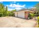 Two-car brick garage with white doors and large driveway at 1650 Lakehurst Ave, Winter Park, FL 32789