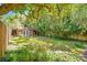Landscaped backyard with brick shed and wooden fence at 1650 Lakehurst Ave, Winter Park, FL 32789