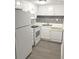 White kitchen with modern appliances and gray tile backsplash at 2557 N Alafaya Trl # 111, Orlando, FL 32826