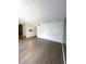 Open living area featuring gray laminate floors and access to kitchen at 2557 N Alafaya Trl # 111, Orlando, FL 32826