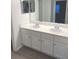 Updated bathroom with double vanity and white cabinets at 2557 N Alafaya Trl # 111, Orlando, FL 32826