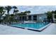 Community swimming pool with surrounding patio furniture at 2557 N Alafaya Trl # 111, Orlando, FL 32826