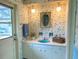 Small bathroom with blue sink, floral wallpaper and a white vanity at 349 Bodie St, Longwood, FL 32750