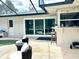 Relaxing pool area with patio furniture and sliding glass doors at 349 Bodie St, Longwood, FL 32750
