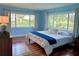 Bright bedroom with large windows, hardwood floors, and a king-size bed at 349 Bodie St, Longwood, FL 32750