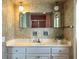 Bathroom with a vanity, tri-fold mirror and floral wallpaper at 349 Bodie St, Longwood, FL 32750