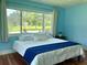 Bright bedroom with large windows, hardwood floors, and a king-size bed at 349 Bodie St, Longwood, FL 32750
