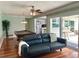 Gathering room with a leather couch and view into kitchen at 349 Bodie St, Longwood, FL 32750