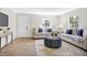 Bright living room featuring light beige couches and a patterned ottoman at 1500 N Clearview Ave, Deland, FL 32724