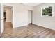 Spacious bedroom with wood-look flooring and access to hallway at 1500 N Clearview Ave, Deland, FL 32724