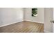 Bedroom with wood-look flooring and a window at 1500 N Clearview Ave, Deland, FL 32724