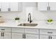Modern kitchen sink with white quartz countertops and black faucet at 1500 N Clearview Ave, Deland, FL 32724