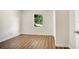 Simple bedroom with wood-look flooring and a window at 1500 N Clearview Ave, Deland, FL 32724