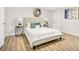 Bright bedroom with a light beige upholstered bed and two end tables at 1500 N Clearview Ave, Deland, FL 32724