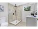 Modern bathroom with walk-in shower, white vanity, and quartz countertop at 1500 N Clearview Ave, Deland, FL 32724