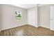 Bedroom with wood-look flooring and a window at 1500 N Clearview Ave, Deland, FL 32724