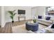Living room with a comfy couch and blue patterned ottoman at 1500 N Clearview Ave, Deland, FL 32724
