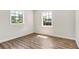 Bright bedroom with wood-look flooring and two windows at 1500 N Clearview Ave, Deland, FL 32724