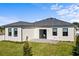 Well-maintained house with a patio and grassy backyard at 6234 Chorus Dr, Mascotte, FL 34753