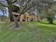 Back exterior of townhomes nestled amongst lush greenery at 744 La Mirage St, Davenport, FL 33897