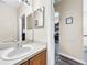 Clean bathroom with single sink vanity and wood cabinets at 744 La Mirage St, Davenport, FL 33897