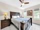 Main bedroom with dark wood furniture and ceiling fan at 744 La Mirage St, Davenport, FL 33897