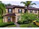 Two-story townhome with brown roof and tan exterior at 744 La Mirage St, Davenport, FL 33897