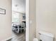 Small half bathroom with toilet and view to dining area at 744 La Mirage St, Davenport, FL 33897
