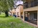 Back exterior of townhomes with private patios and green space at 744 La Mirage St, Davenport, FL 33897